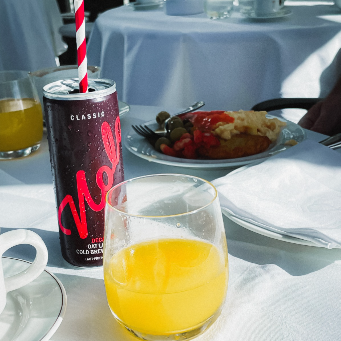 Photo of Nolo Classic on a hotel breakfast table with glass of orange juice