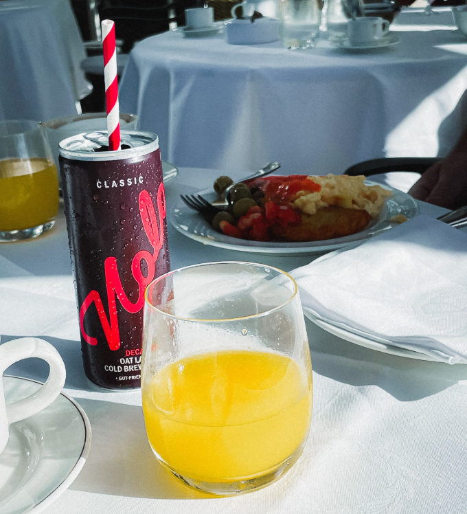Photo of Nolo Classic on a hotel breakfast table with glass of orange juice