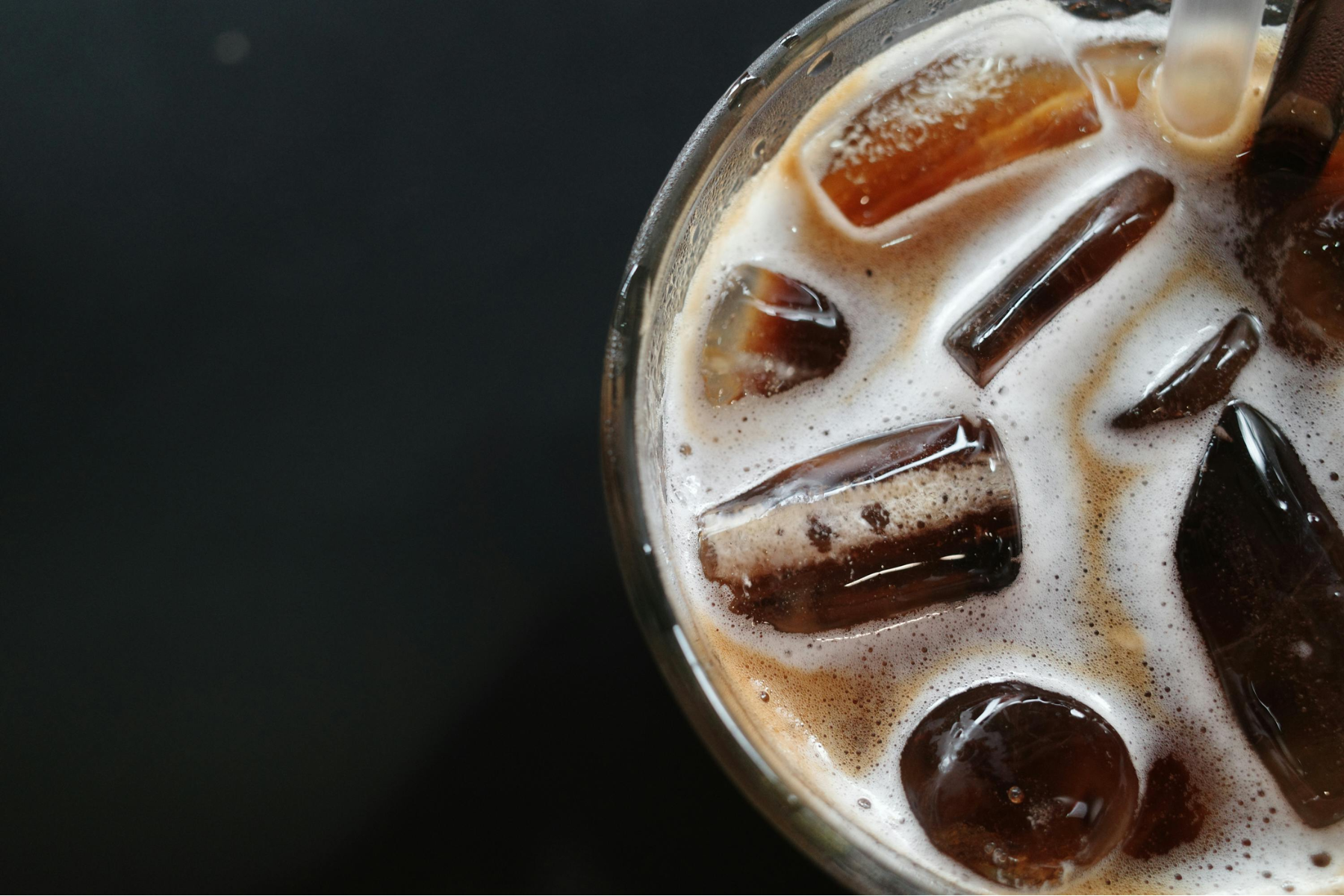 Top down view of a glass of cold brew coffee with ice in it